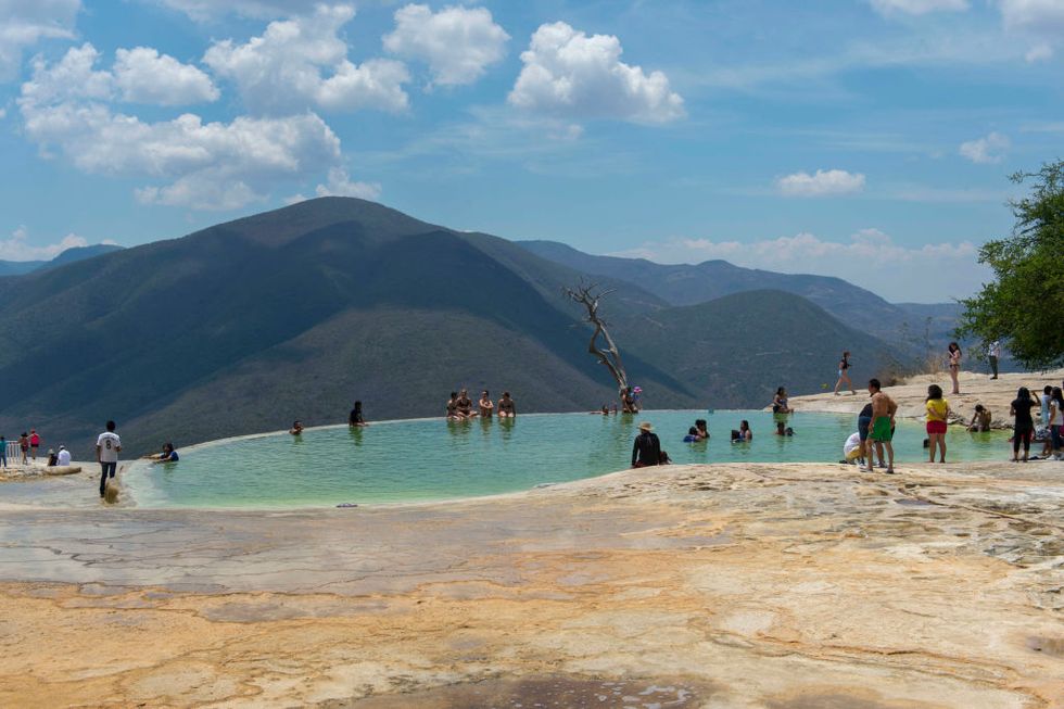 People bathing in the artificial pool filled with water from