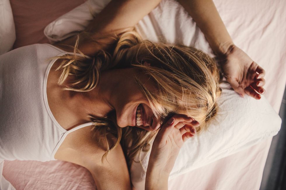 portrait of a young beautiful woman waking up, with a smile on her face