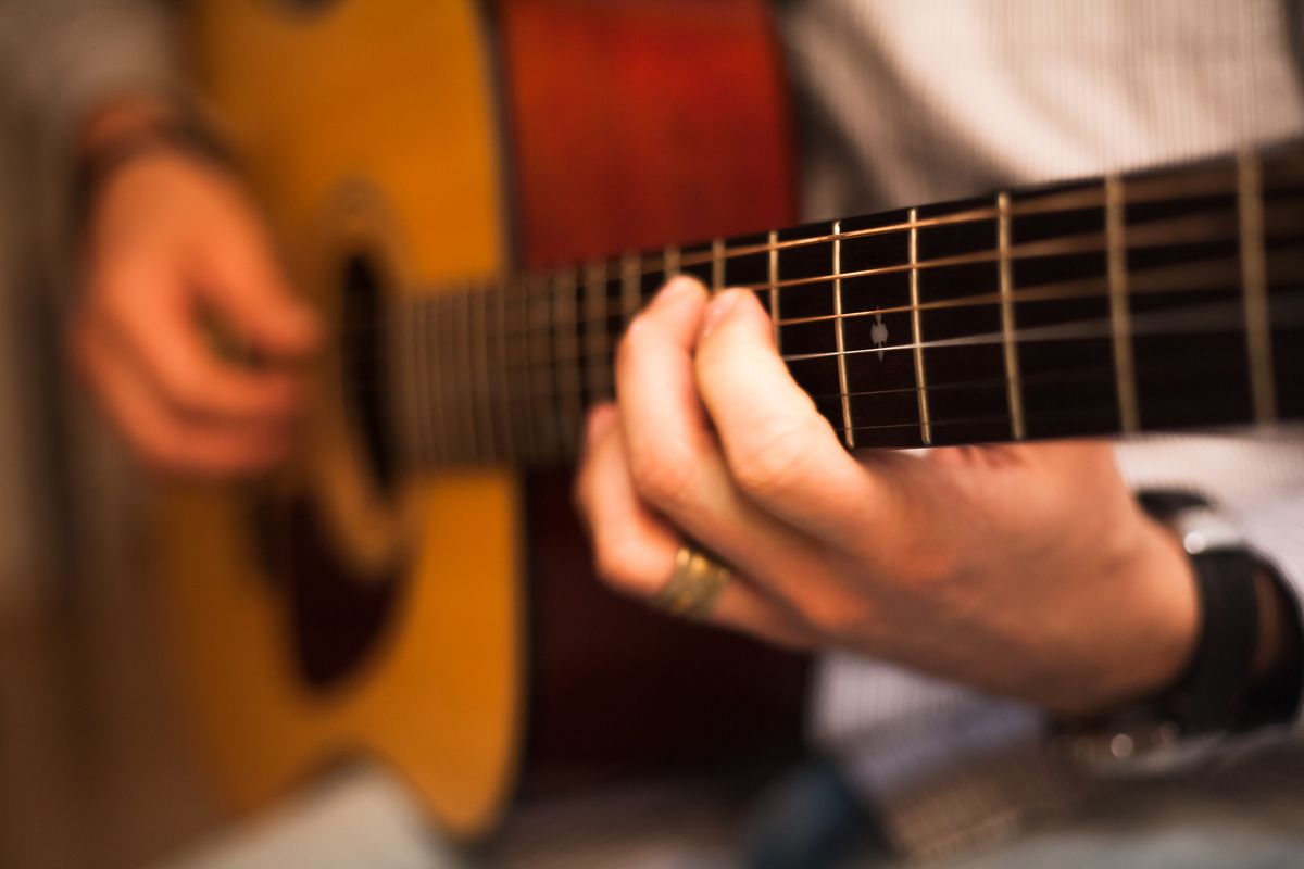hands playing a guitar
