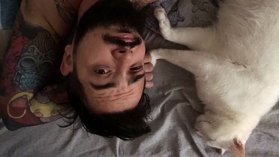Man With White Cat In Bed