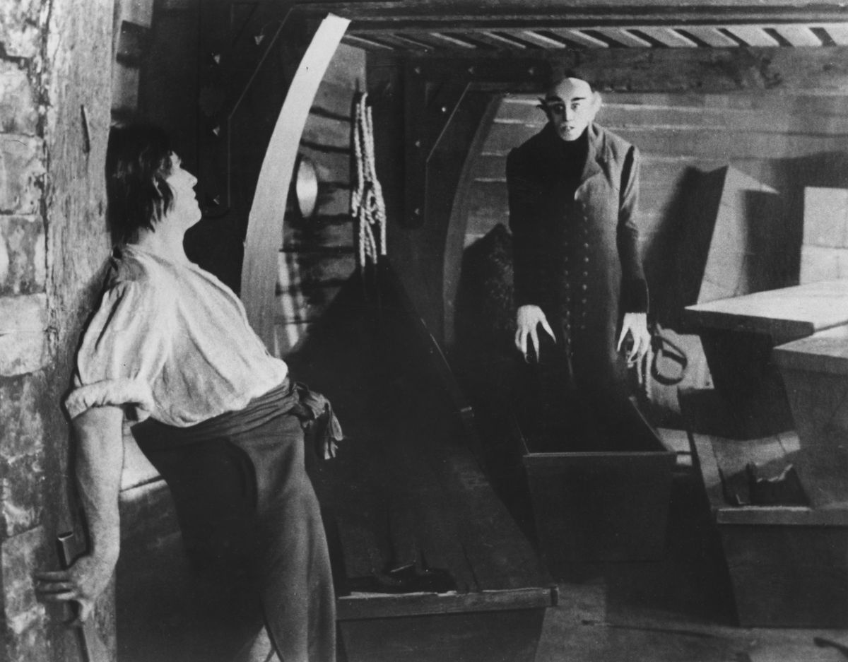 on board the demeter, the vampire count orlok, played by german actor max schreck emerges from one of his coffins before they can be destroyed by the ships first mate, played by wolfgang heinz, in a scene from nosferatu