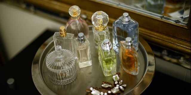 Perfume bottles on a tray by a mirror