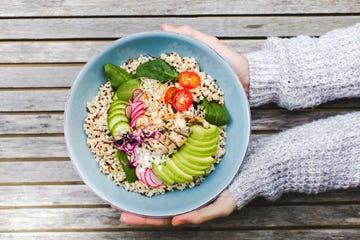 Cropped Hands Holding Salad Bowl On Table