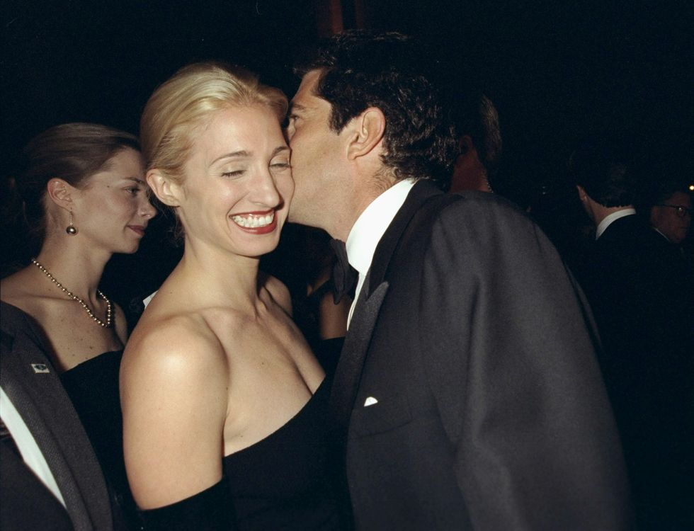 Carolyn Bessette Kennedy is amused by the whisperings of her husband, John F. Kennedy Jr., at the Municipal Art Society gala at Grand Central Terminal.