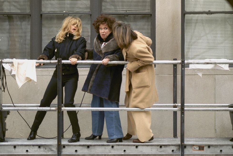united states   january 16  goldie hawn, bette midler and diane keaton l to r hang onto a building scaffold as they film the movie first wives club at fifth ave and 87th st,  photo by richard corkeryny daily news archive via getty images