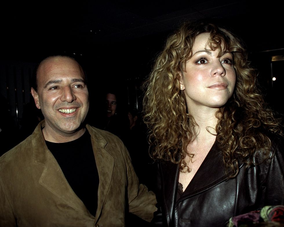 Tommy Matola nd Mariah Carey at movie premiere of "The Devil