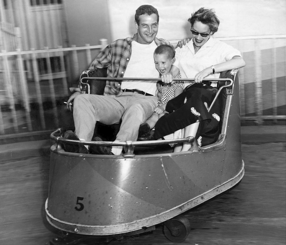 Members of the cast of the hit Broadway show "The Desperate Hours" enjoy an outing to Rockaway's Playland. Here Paul Newman rides the Whip with his first wife Jackie and their son.