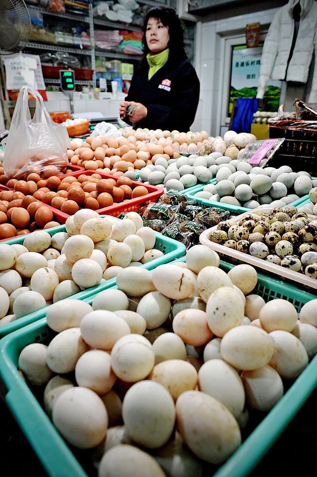 A vendor selling eggs waits for customer