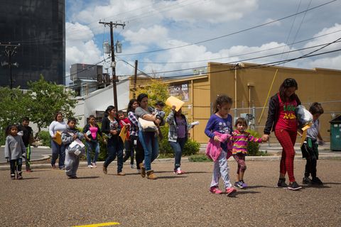 Immigrants walk to a nearby Catholic Charities relief center after being dropped off at a bus station shortly after release from detention through 'catch and release' immigration policy. 'Catch and release' is a protocol under which people detained by authorities as unlawful immigrants can be released while they wait for a hearing. 