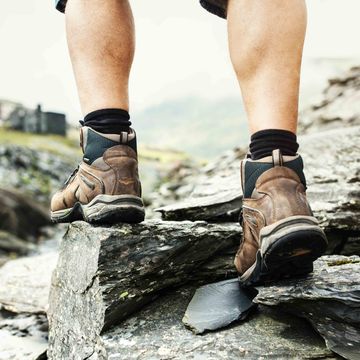 Footwear, Shoe, Leg, Hiking boot, Rock, Human leg, Adventure, Hiking equipment, Outdoor shoe, Recreation, 