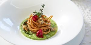 whole spahgetti with dried tomatoes and green beans sauce restaurant dish