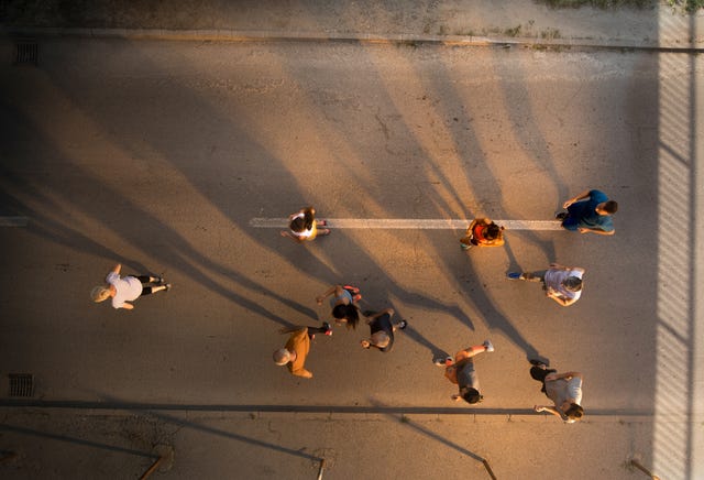 high angle view of large group of runners running during a marathon race on the road copy space