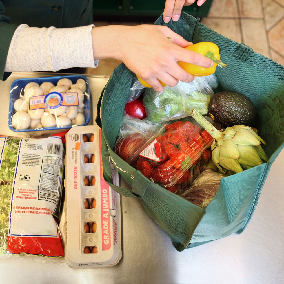 Woman bagging groceries