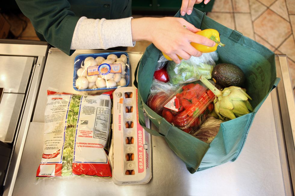 Woman bagging groceries
