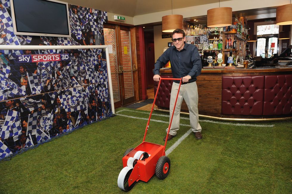 london, england   march 31  landlord, dave webster of the fulham mitre, makes final preparations to his freshly laid pub turf on march 31, 2010 in london, england, to celebrate the arrival of sky 3d this saturday for the top of the table clash between manchester united and chelsea smith said, if you cant make it to old trafford, were bringing the stadium atmosphere to west london were on of the first pubs to be showing sky 3d and i cant wait to see the players in my pub  photo by ian gavangetty images for sky