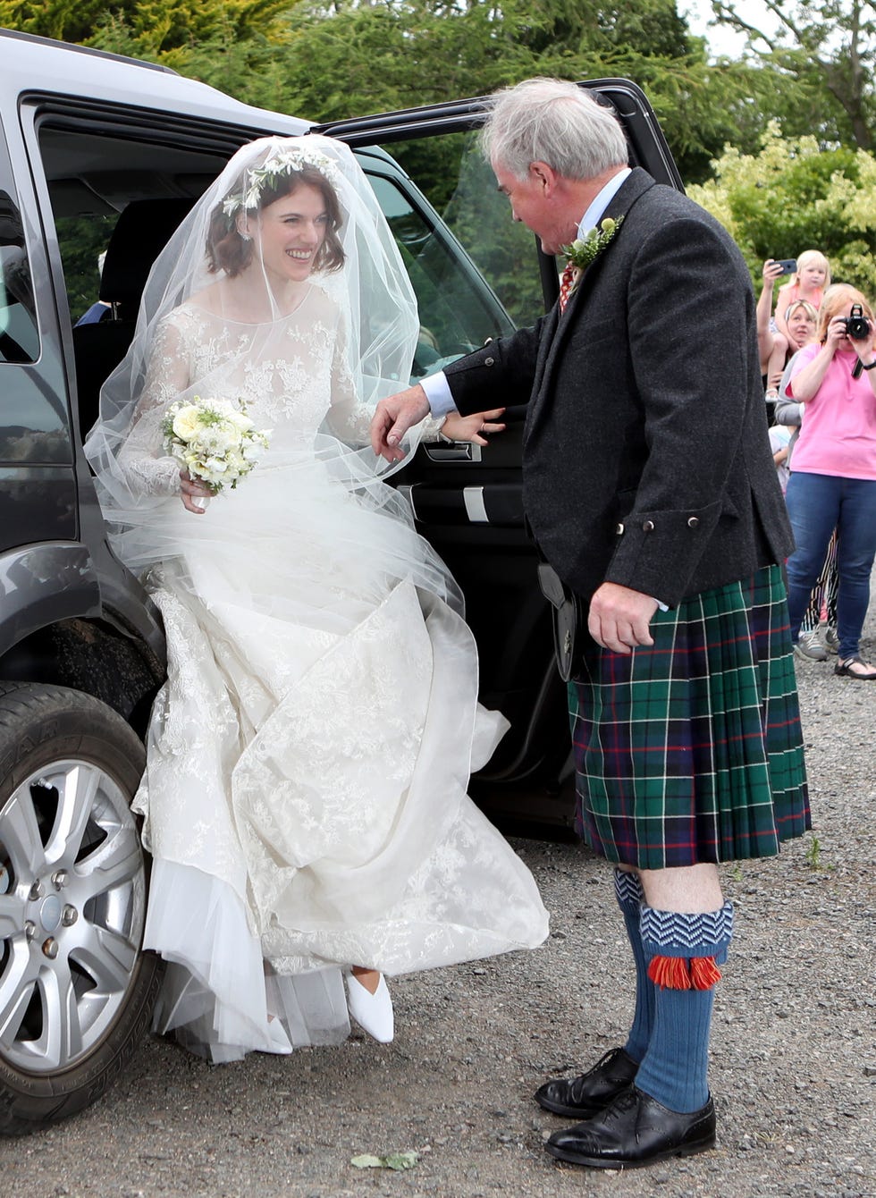 Bride, Wedding dress, Photograph, Ceremony, Wedding, Bridal clothing, Luxury vehicle, Kilt, Dress, Gown, 