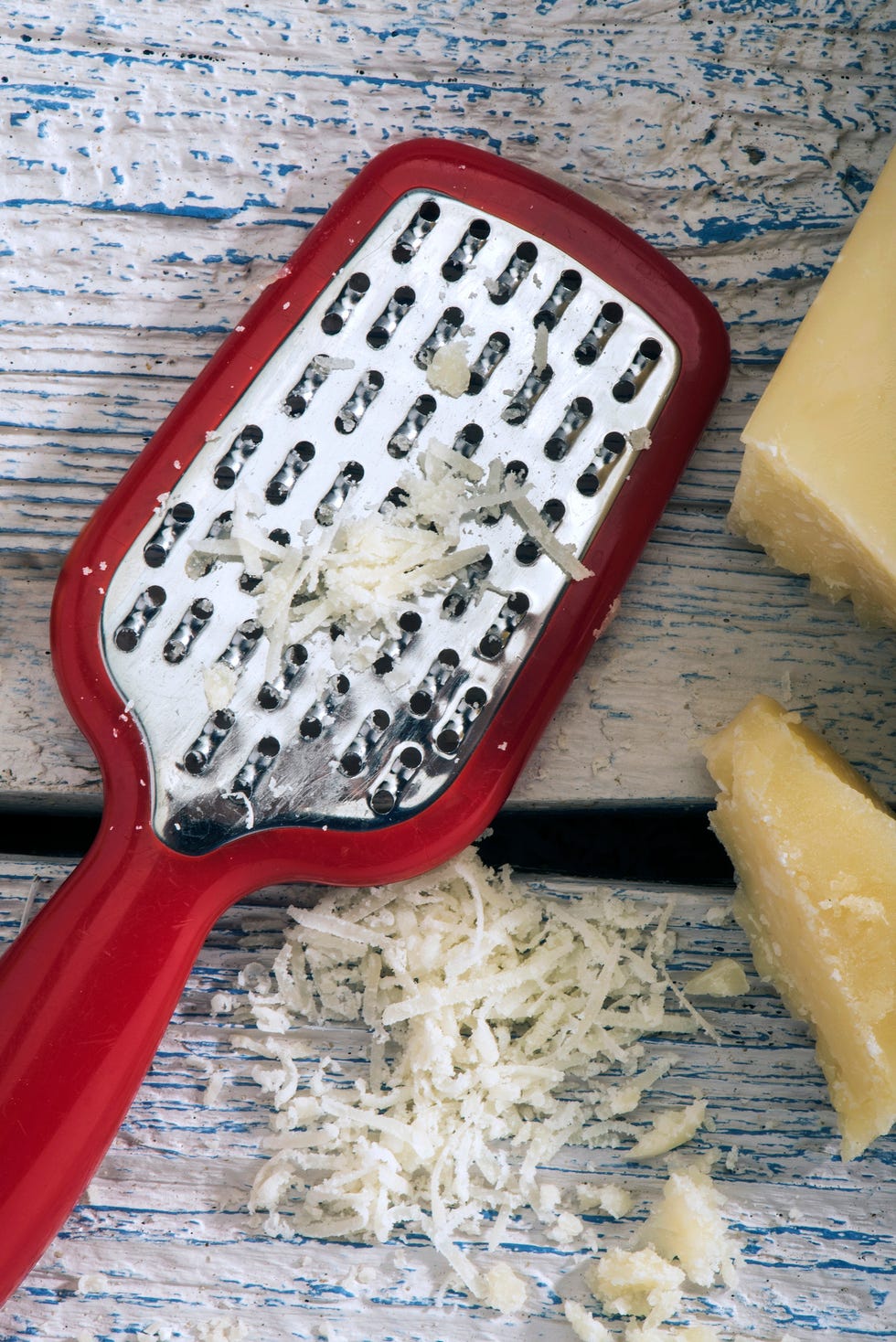 parmesan cheese with grater on wooden background