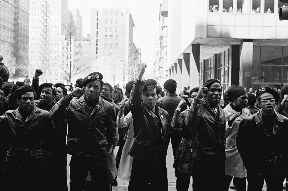 view of black panther party members as they demonstrate, fists raised, on centre street outside the new york county criminal court, new york, new york, april 11, 1969 the demonstration was about the panther 21 trial, over jailed black panther members accused of shooting at police stations and a bombing all of whom were eventually acquitted visible in the background is the new york county criminal court at 100 court street photo by david fentongetty images