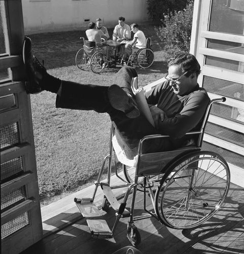 subject actor marlon brando sitting in a wheelchair reading on the set of "the men,"  november, 1949photographer  edward clarktime inc ownmerlin  1152398