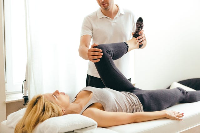 physiotherapist examining runner for sports massage