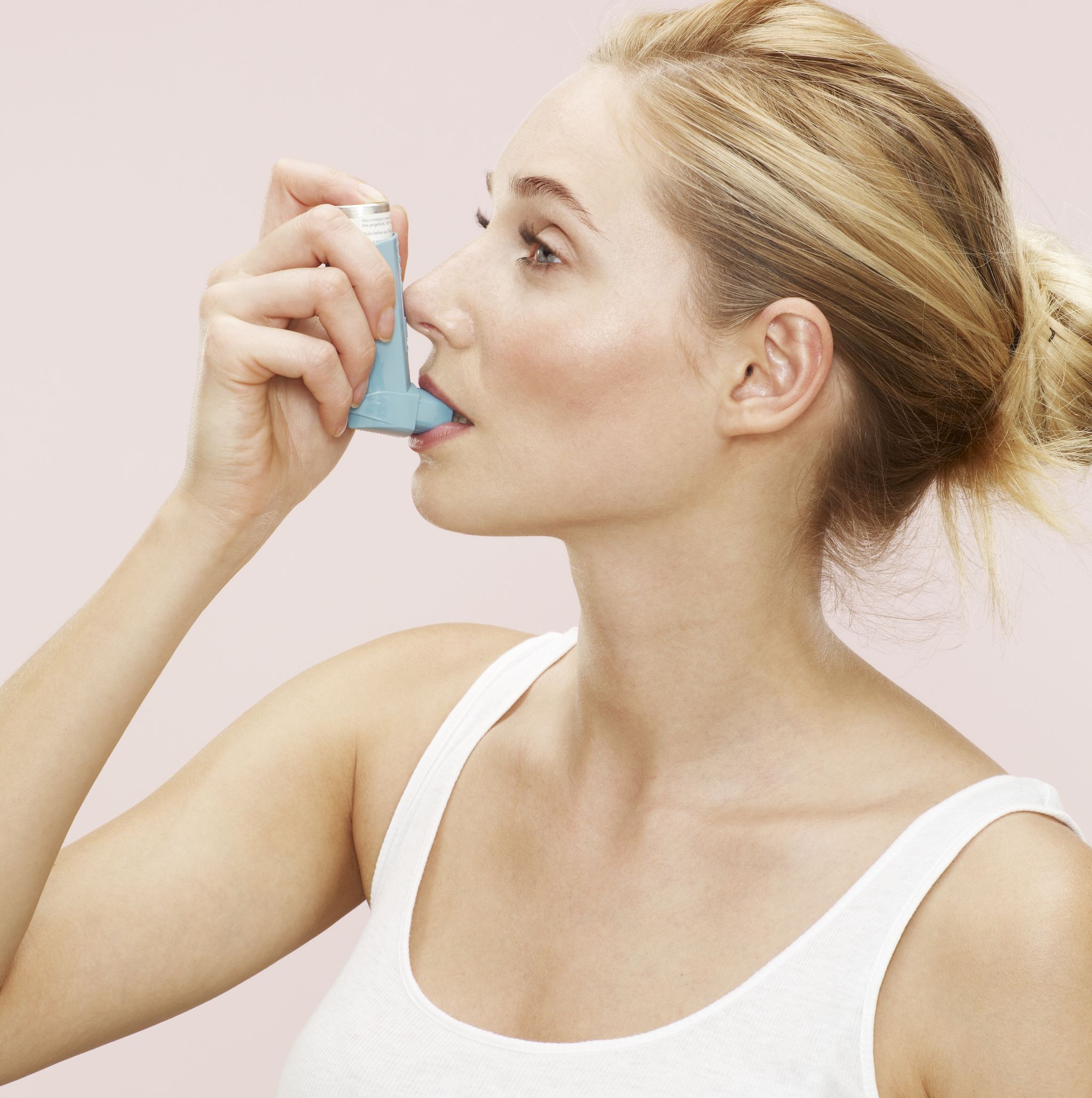woman using blue inhaler