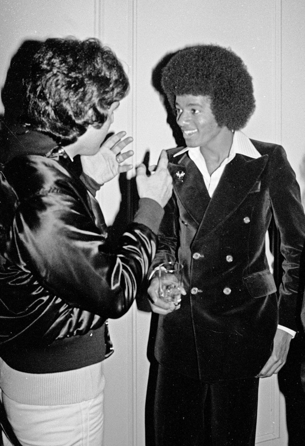 hairstyle, black and white, suit, monochrome, outerwear, gesture, photography, monochrome photography, style, retro style