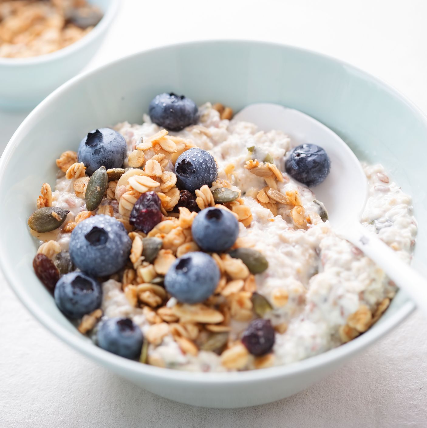 joe wicks overnight oats recipes overnight oats with granola, dried cranberries, pumpkin seeds and blueberries