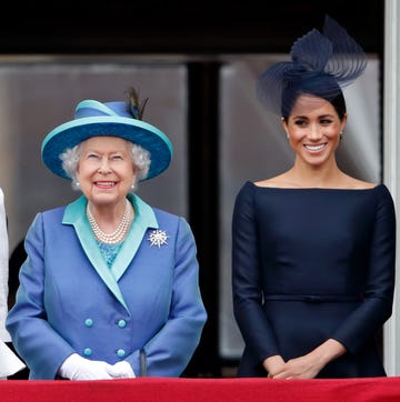 Meghan Markle stands next to Queen Elizabeth