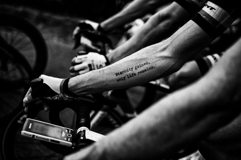 a tattoo on usas chad hagas forearm is pictured as he rides in the pack during the seventh stage of the 105th edition of the tour de france cycling race between fougeres and chartres, western france, on july 13, 2018 photo by marco bertorello  afp  black and white version        photo credit should read marco bertorelloafp via getty images
