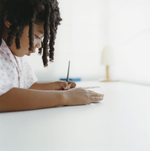 Young Girl Writing at Desk