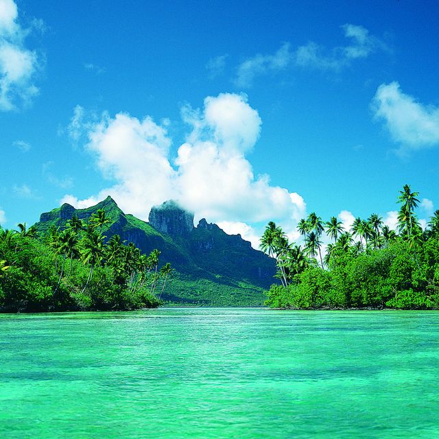 beautiful polynesian island seen from the sea with mountain in the distance