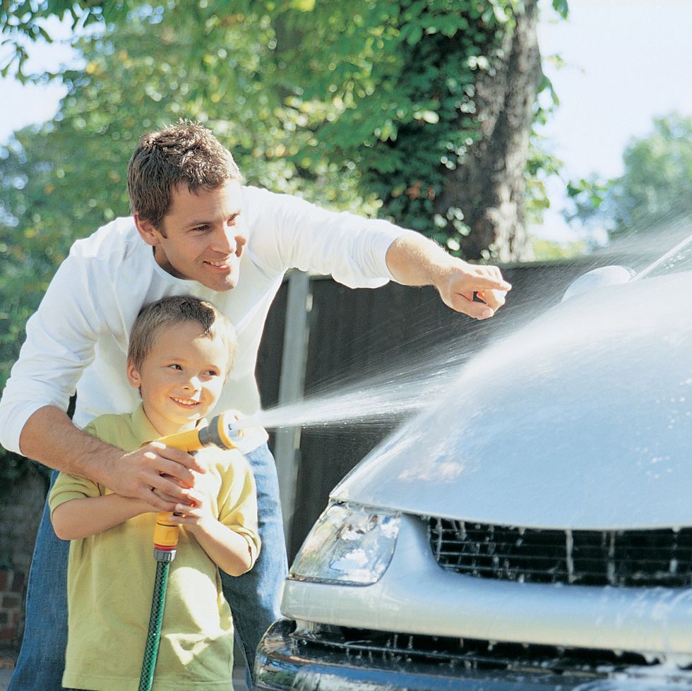 son helping his father to wash the car