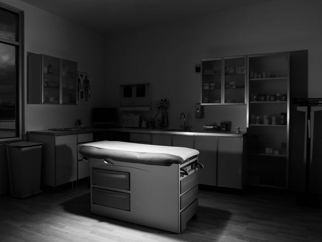 empty medical exam room, spotlight on exam table