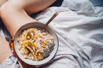 Close-Up Of Woman Having Breakfast In Bed