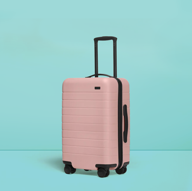 pink away suitcase on a blue background