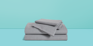 set of the best bed sheets tested by the good housekeeping institute on a blue background
