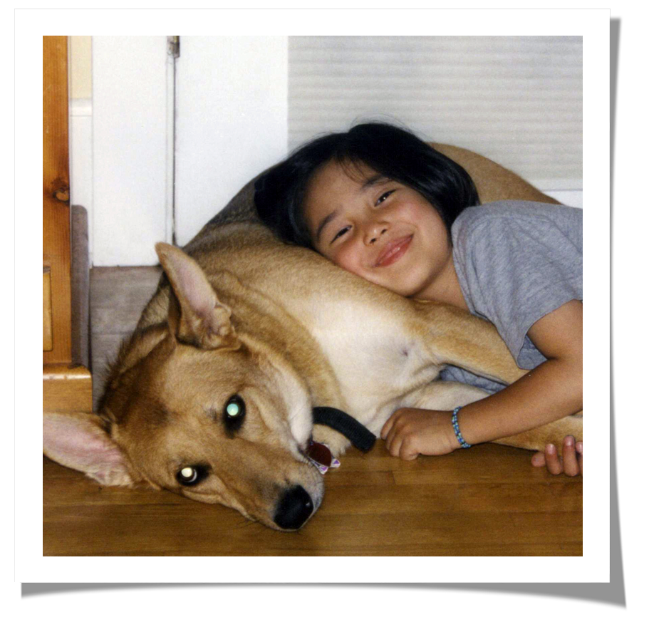 author's daughter on the floor with friday the dog