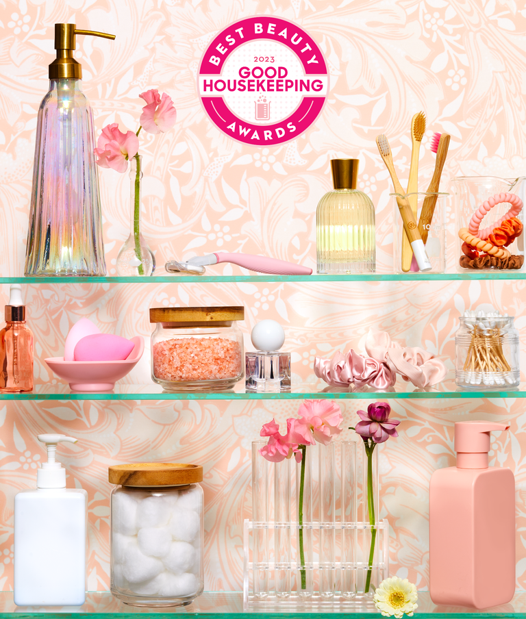 medicine cabinet with pink floral wall paper stocked with beauty products