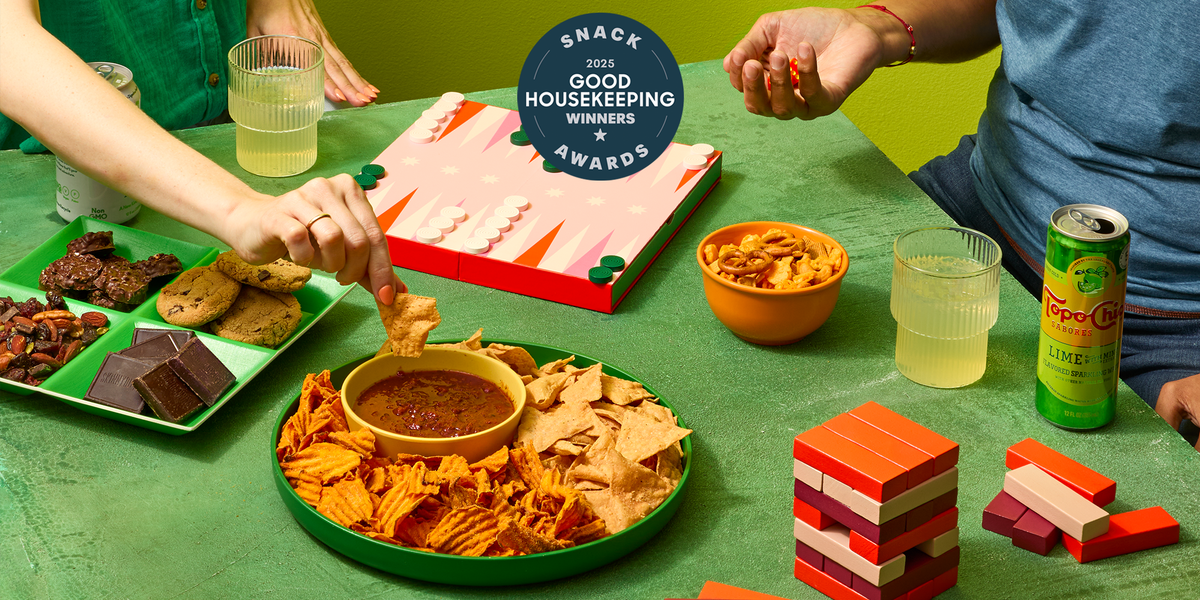 A green table with board games and assorted snacks a green table with board games and assorted snacks
