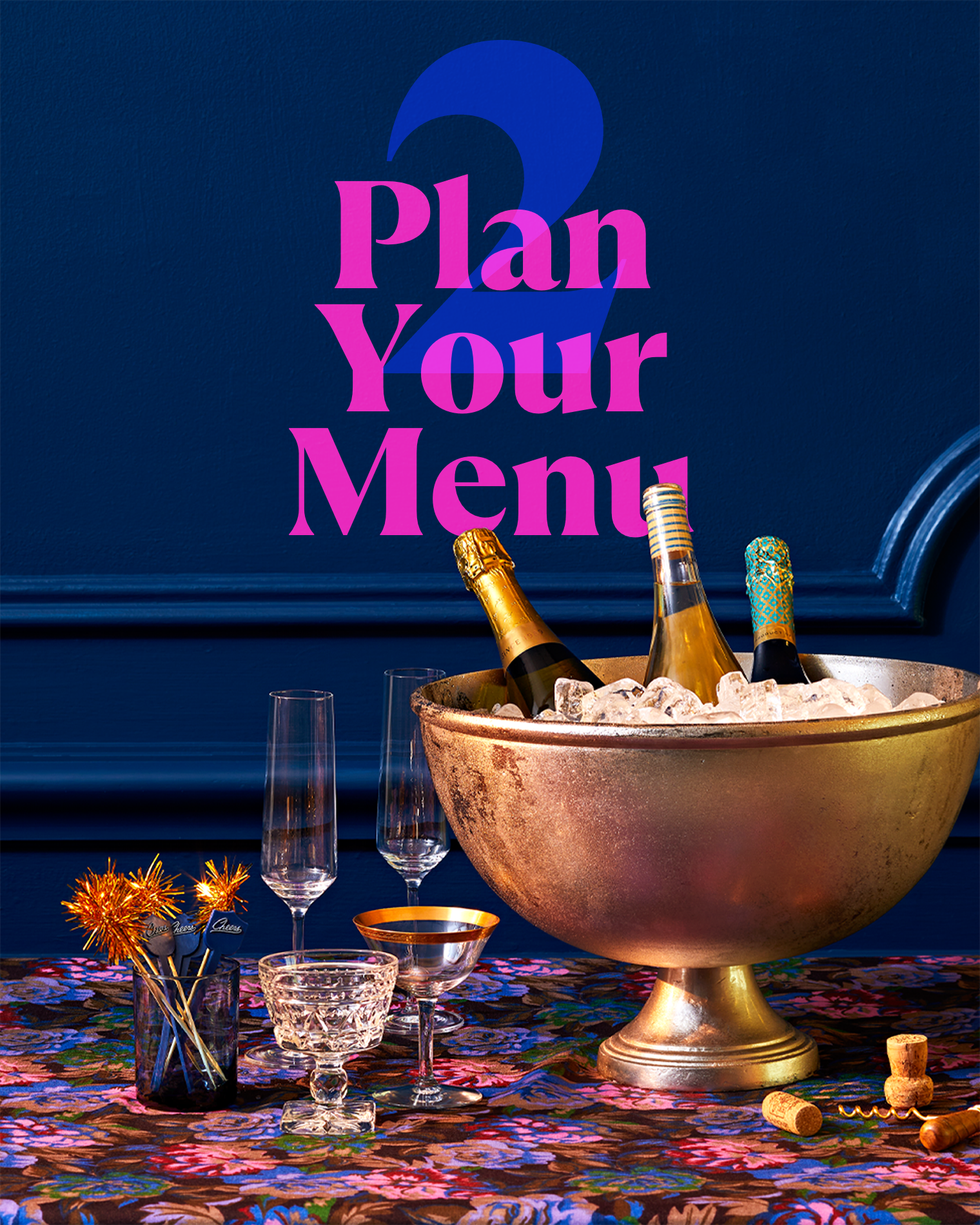 a table setting with a silver bowl of champagne and festive glassware