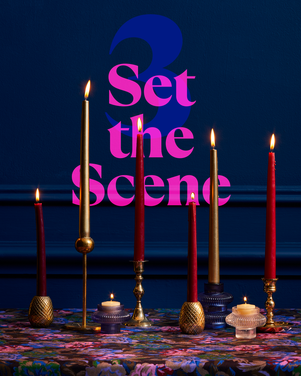 decorative candle arrangement with a floral tablecloth and wall text