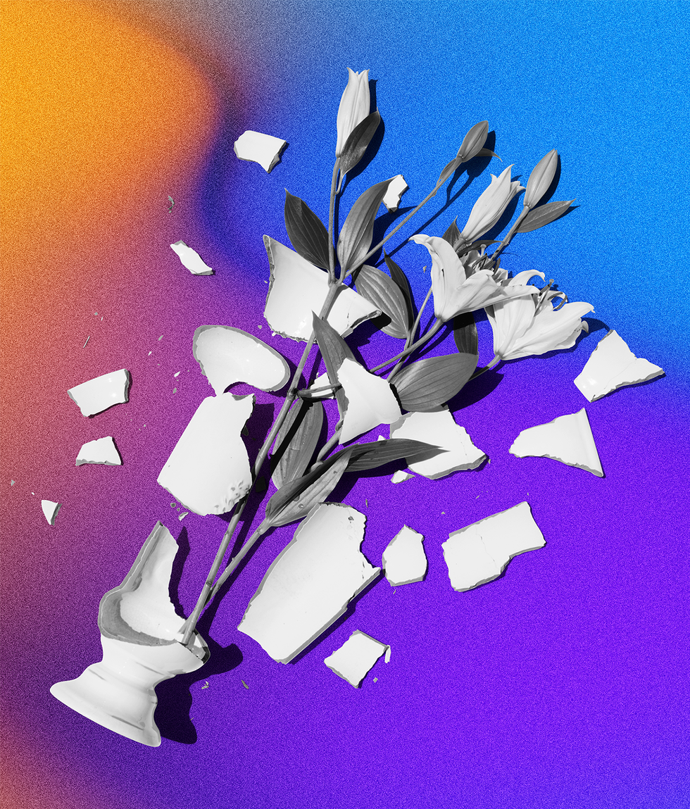 shattered vase with flowers on the floor