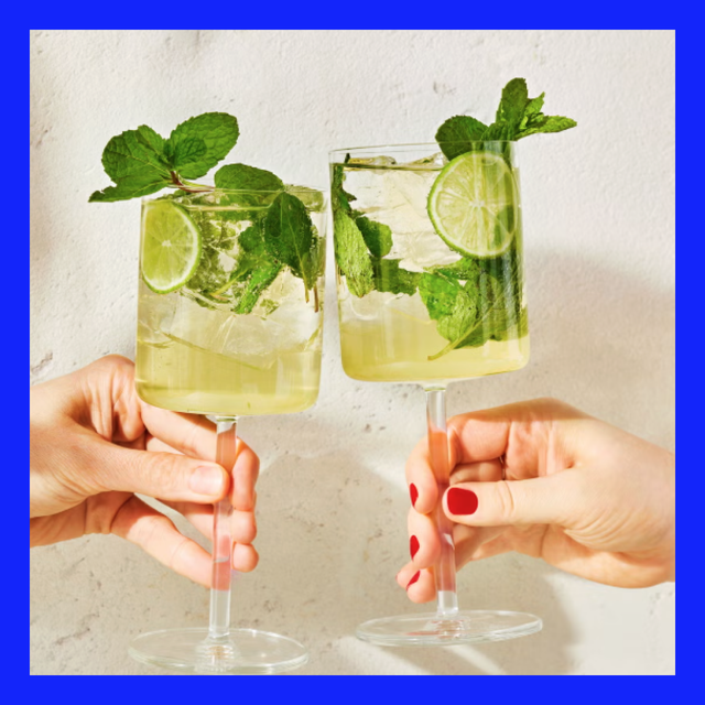 two cocktails with mint and lime being toasted