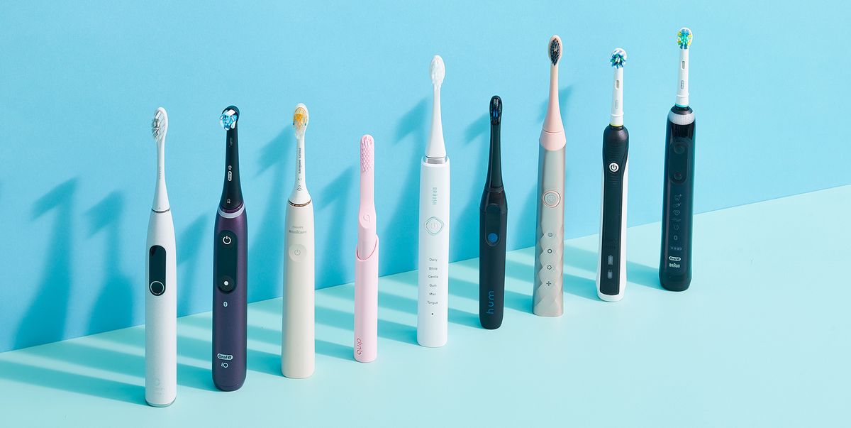 9 electric toothbrushes lined up next to each other on blue background