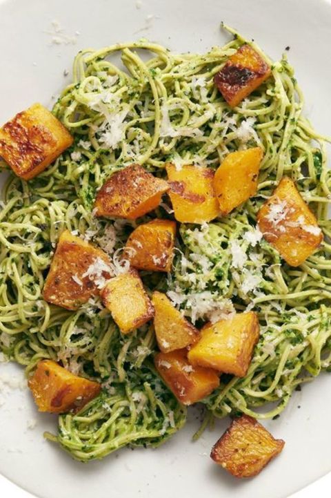 a close up of soybean pasta with kale pesto and squash