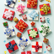 assortment of wrapped presents in green red blue gold on a blue background
