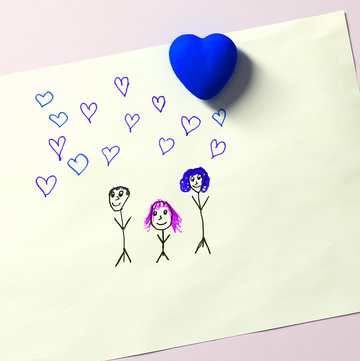 a piece of paper with a drawing of a family of three on it