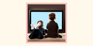 two young boys from behind watching television