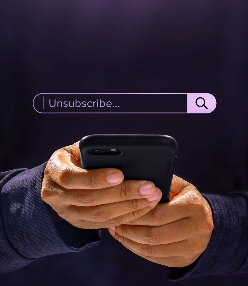 a person holding a phone typing unsubscribe