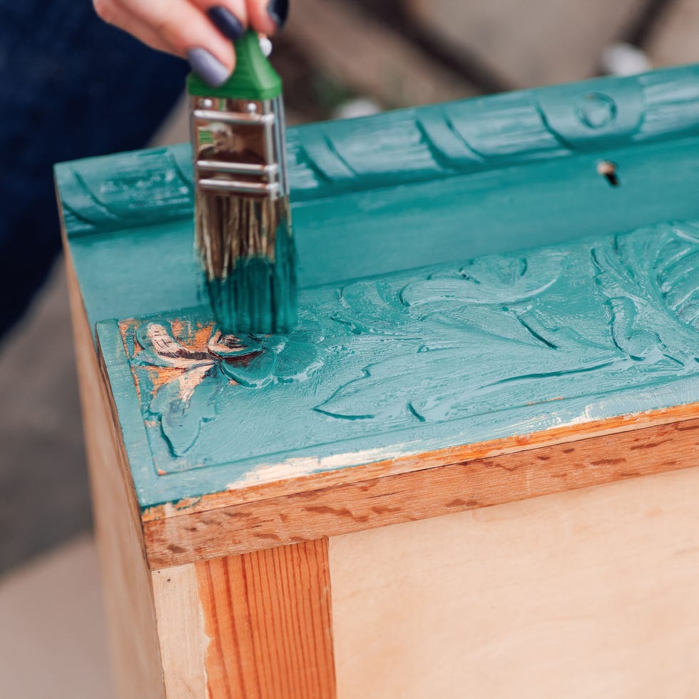 macro brush with blue or green paint updates old wooden furniture for reuse and environmental care